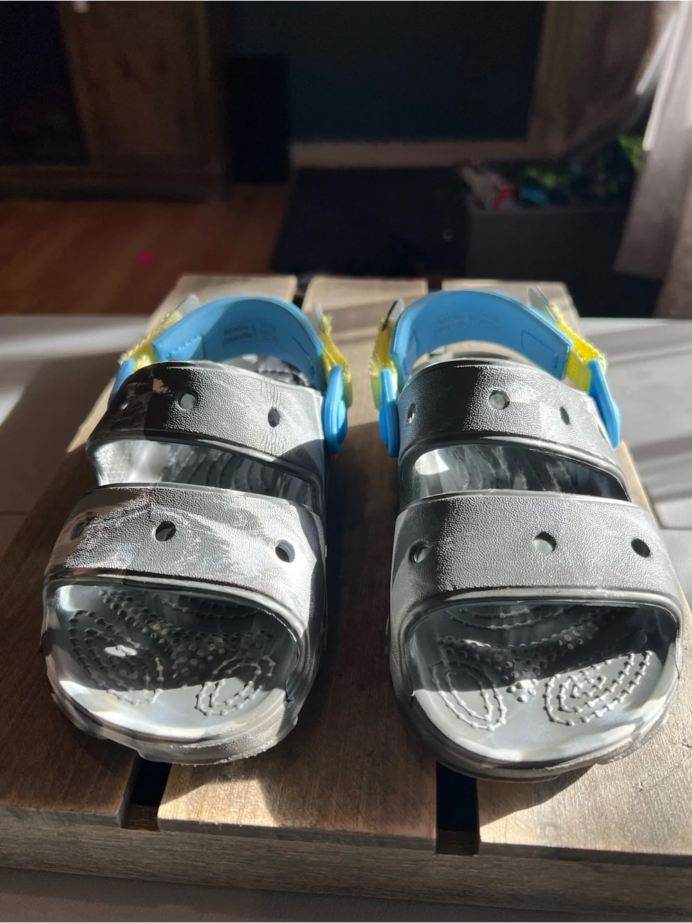 CROCS Kids Black Sandals with Blue and Yellow Accents